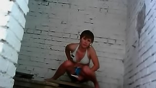 Busty teen hottie takes a piss in the corner